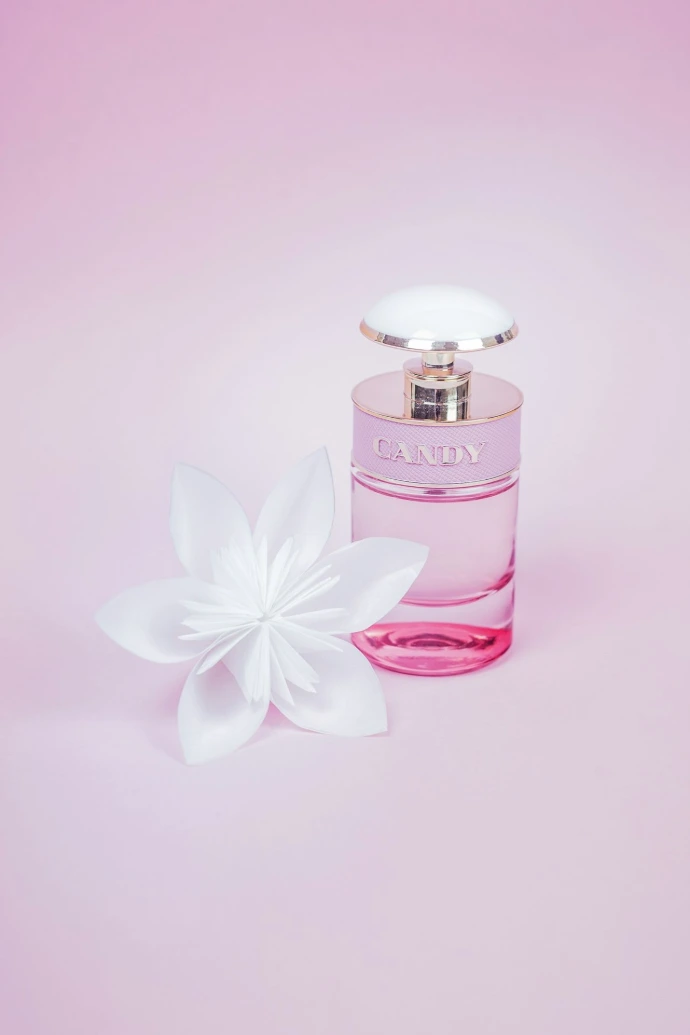 pink perfume bottle with white flower